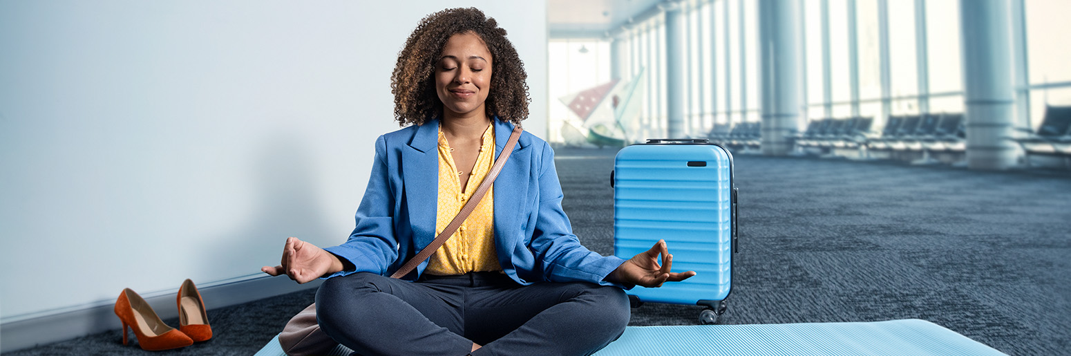 Woman peacefully meditation in an airport