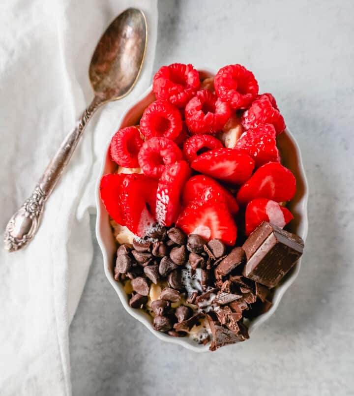 Strawberry Raspberry Chocolate Chip Oatmeal. How to make creamy oatmeal with your favorite toppings combinations. I am sharing a list of all of the popular oatmeal toppings ideas to serve on a cold winter day and how to make the best bowl of oatmeal!