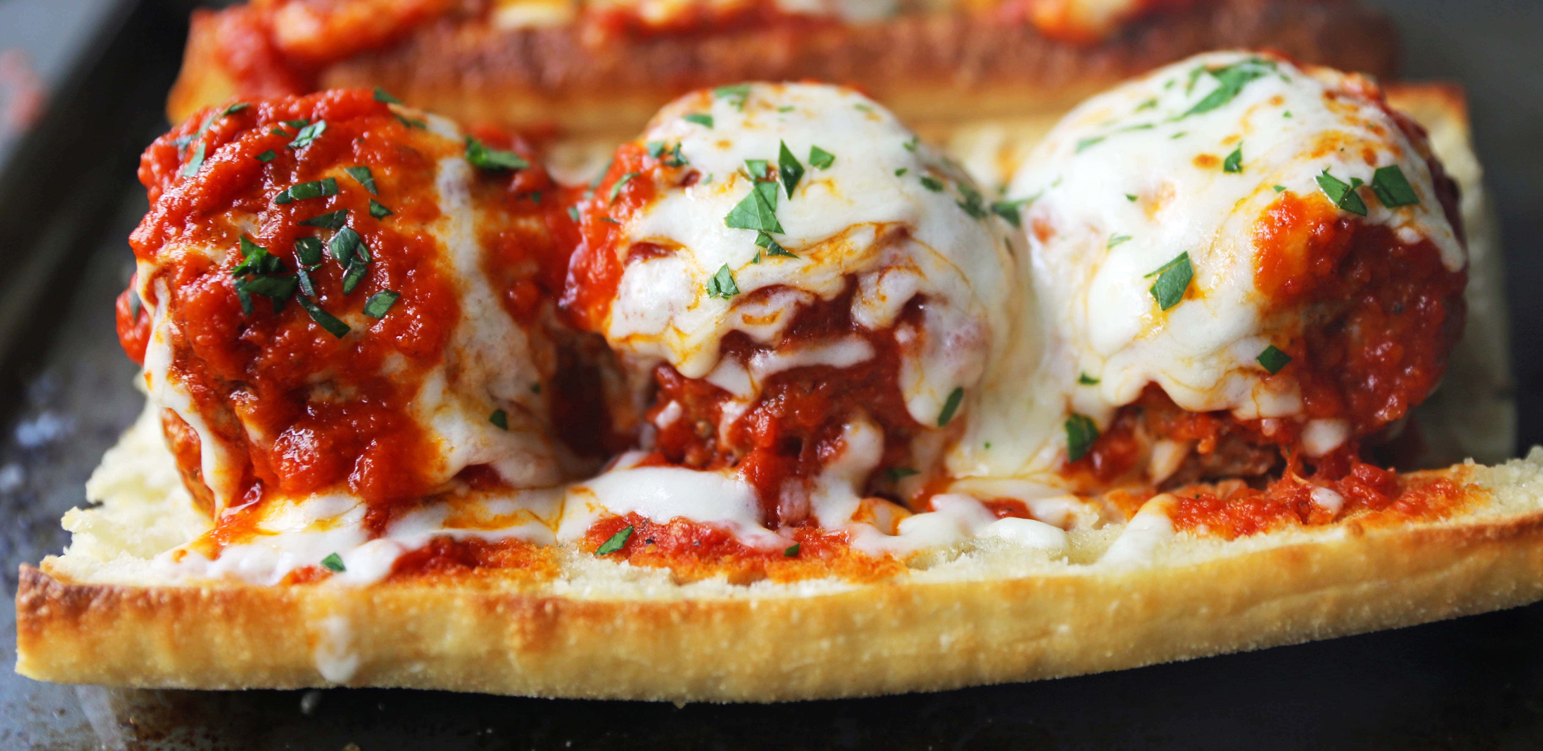 Italian Meatball Subs. Homemade beef parmesan meatballs in a fresh marinara sauce topped with melted mozzarella cheese all on toasted bread. The best meatball sub recipe! www.modernhoney.com #meatballs #meatball #meatballsub