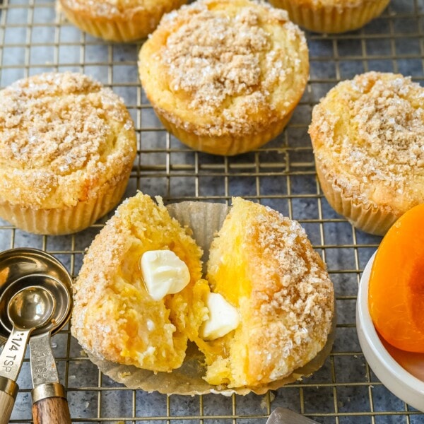 These Peach Cobbler Muffins are made with fresh, juicy peaches topped with a buttery streusel topping. These peach muffins are tender, moist, and bursting with fresh peach flavor and the sweetness of white chocolate chips.