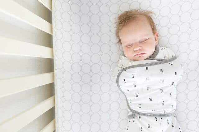 baby sleeping in a swaddling blanket