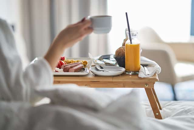 Breakfast in bed, cozy hotel room. concept