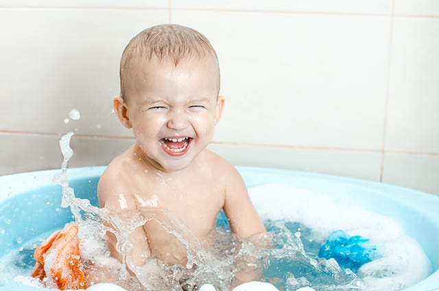 Handsome boy preschooler bathing in the bathroom clean and hygienic