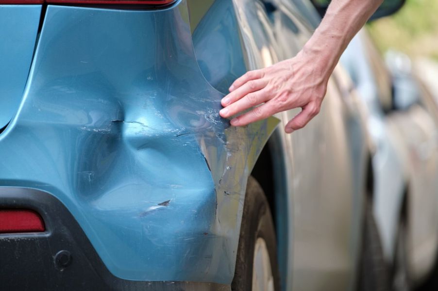 A parking lot hit-and-run collision reveals bumper damage.