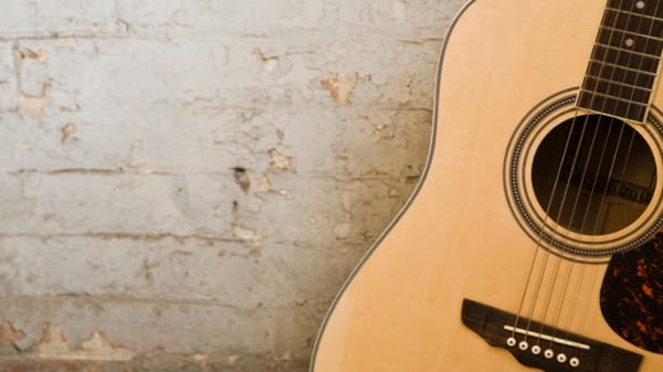 image of guitar leaning against a wall