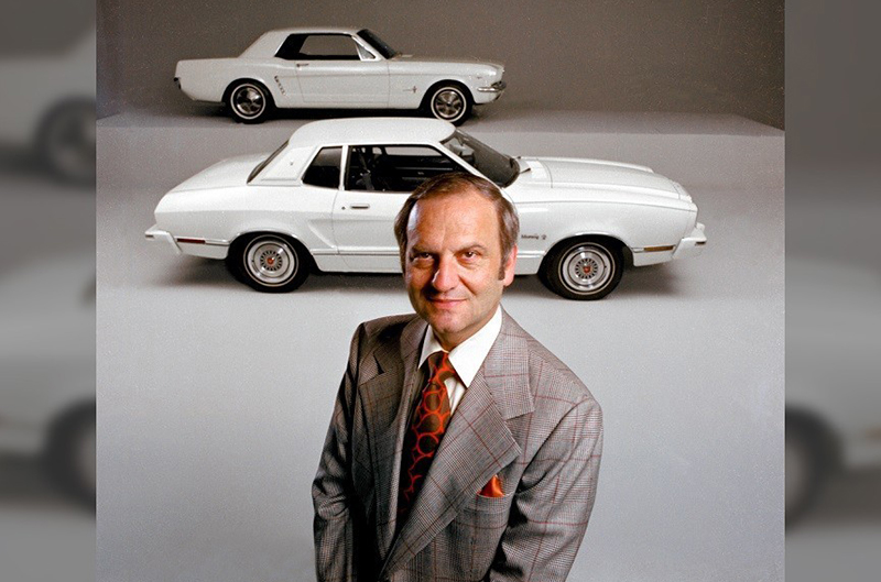 Lee Iacocca with the Mustang II (front) and the original Ford Mustang (rear.)