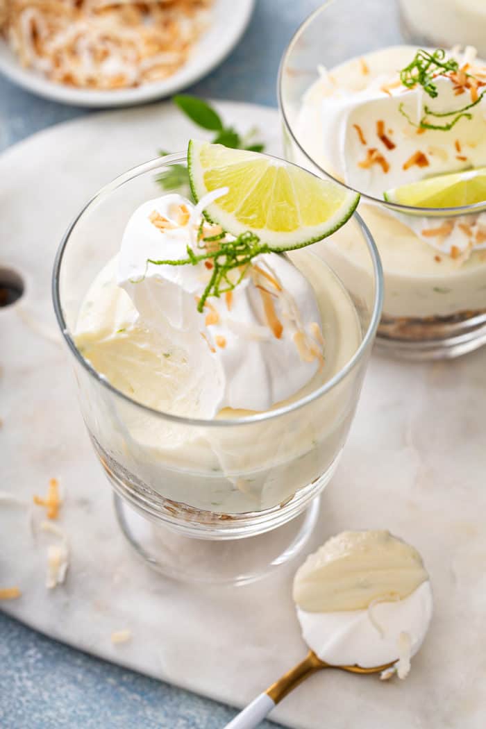 Spoon taking a bite out of a key lime coconut cheesecake