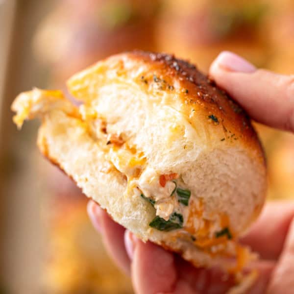 Hand holding a chicken bacon ranch slider.