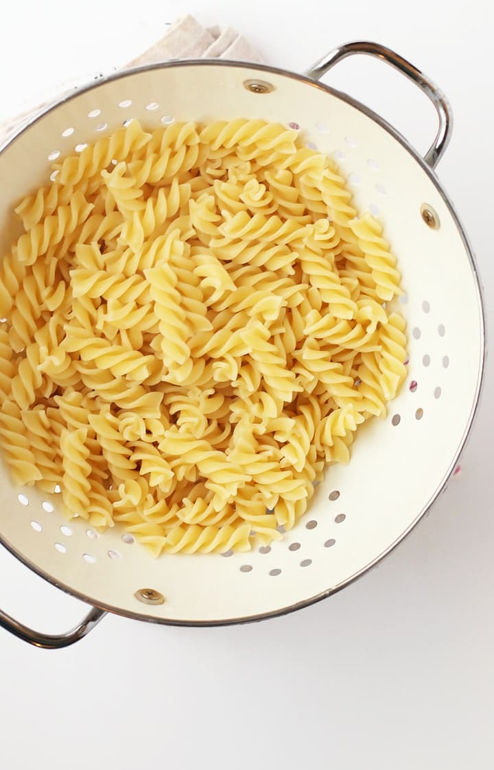 Cooked Fusilli Pasta in a white colander