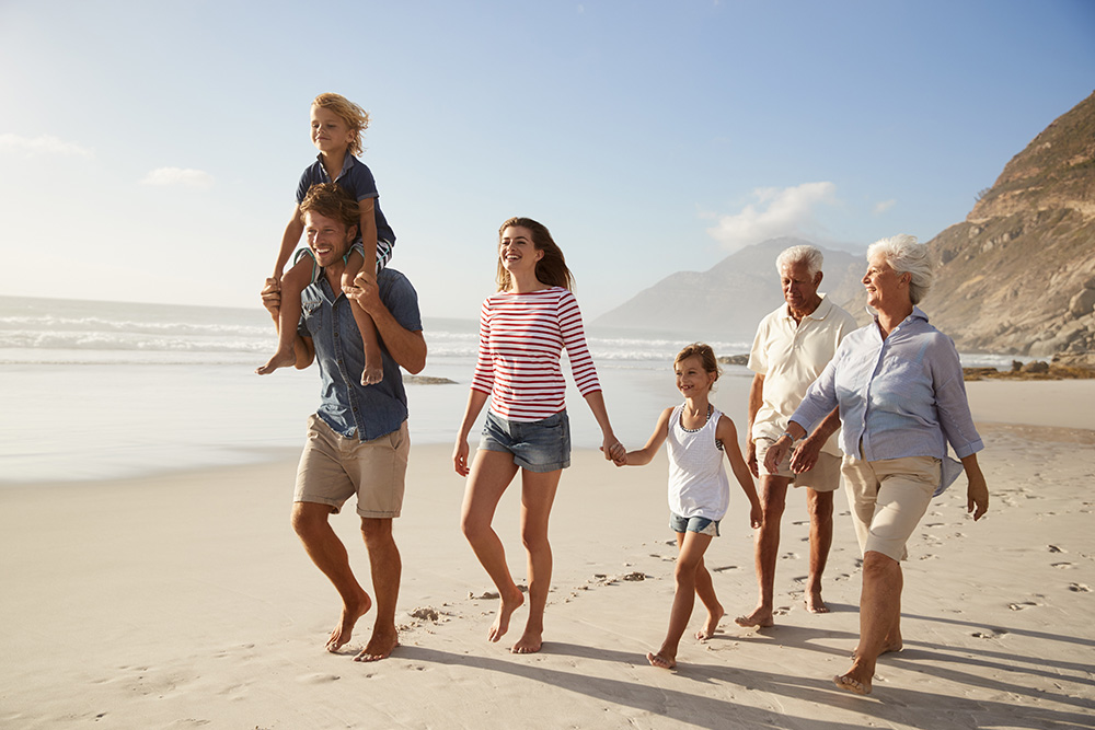 Happy family walking on beach