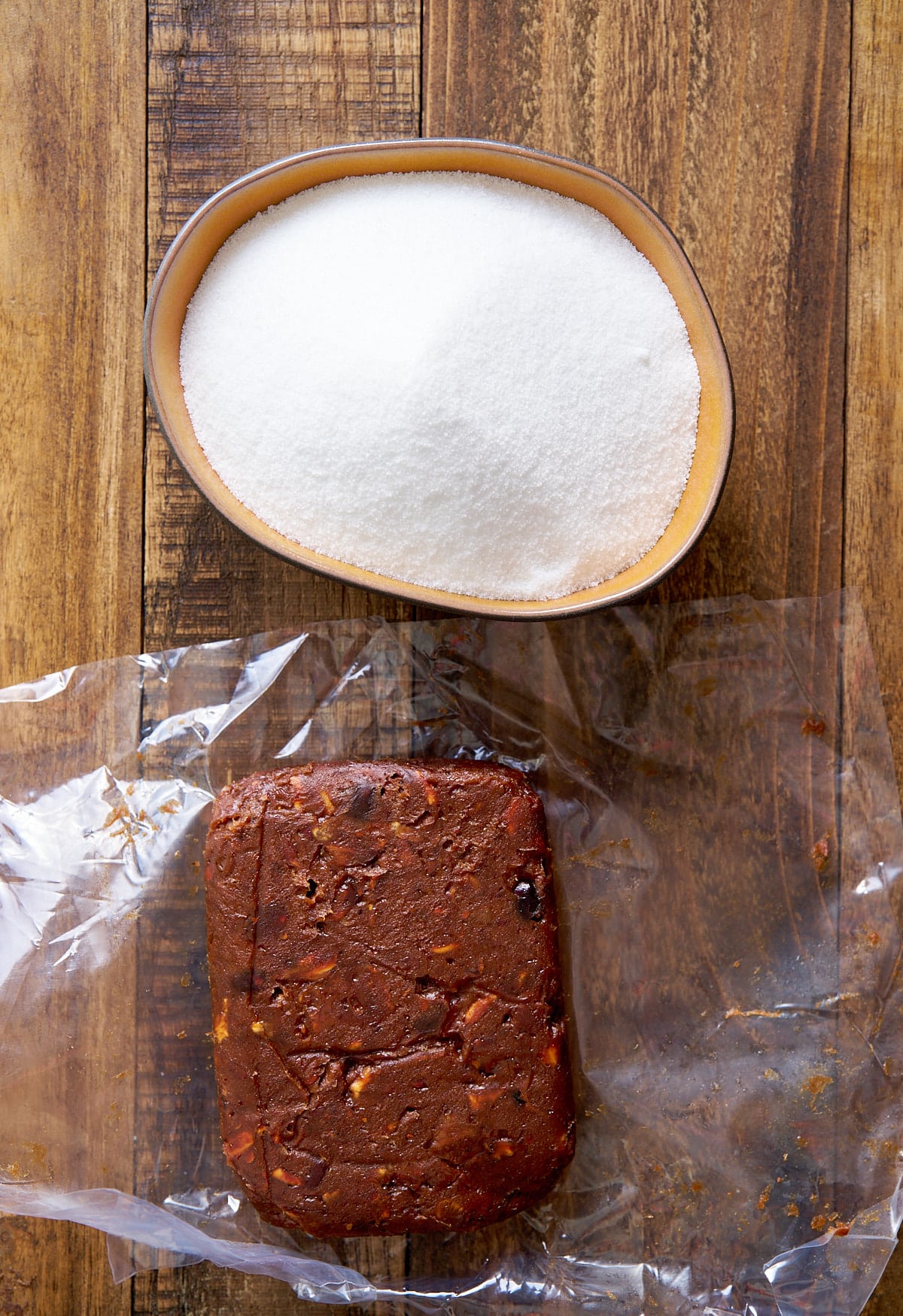 white granulated sugar and tamarind pulp on table