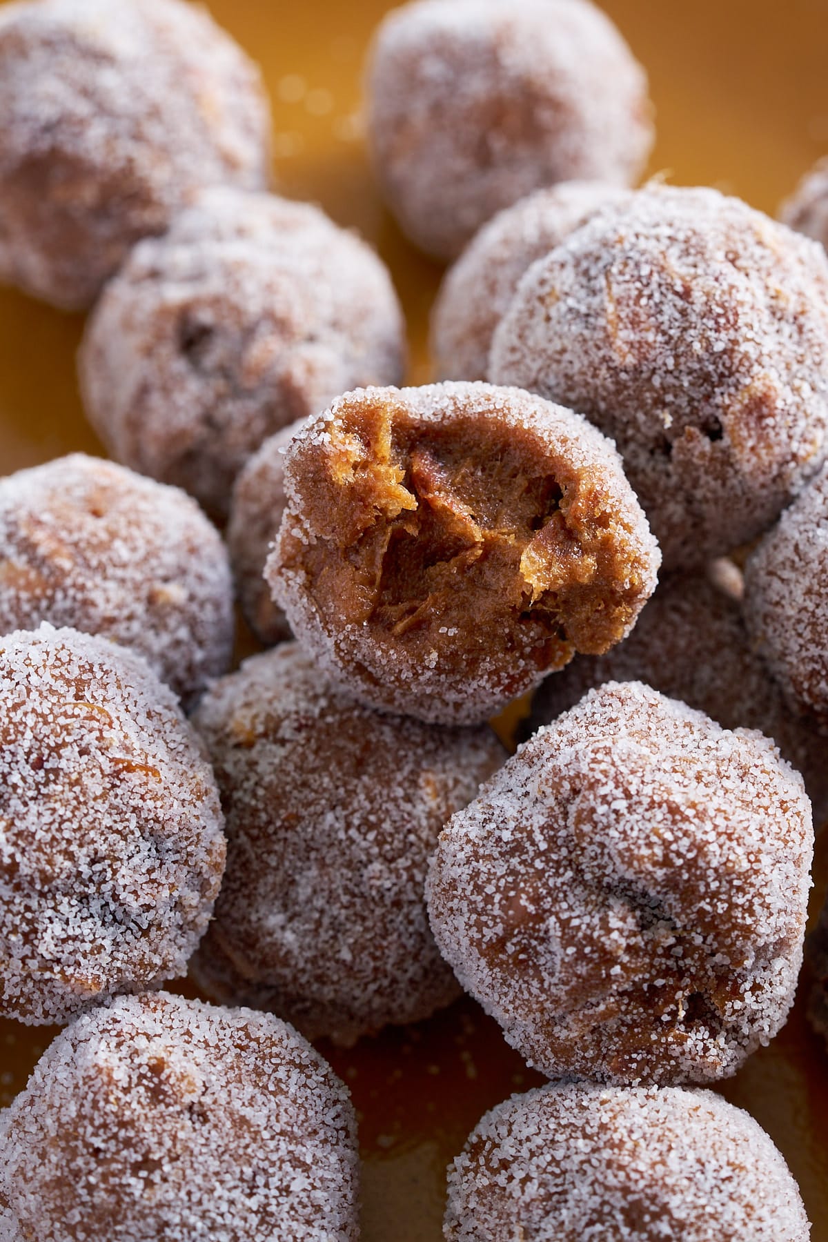 tamarind balls on plate with one with bite taken out