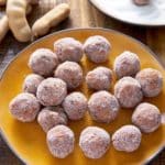 tamarind balls on plate with whole tamarind balls in background