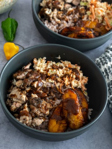 jerk chicken, rice, coleslaw, plantains in bowl to make a jerk chicken bowl