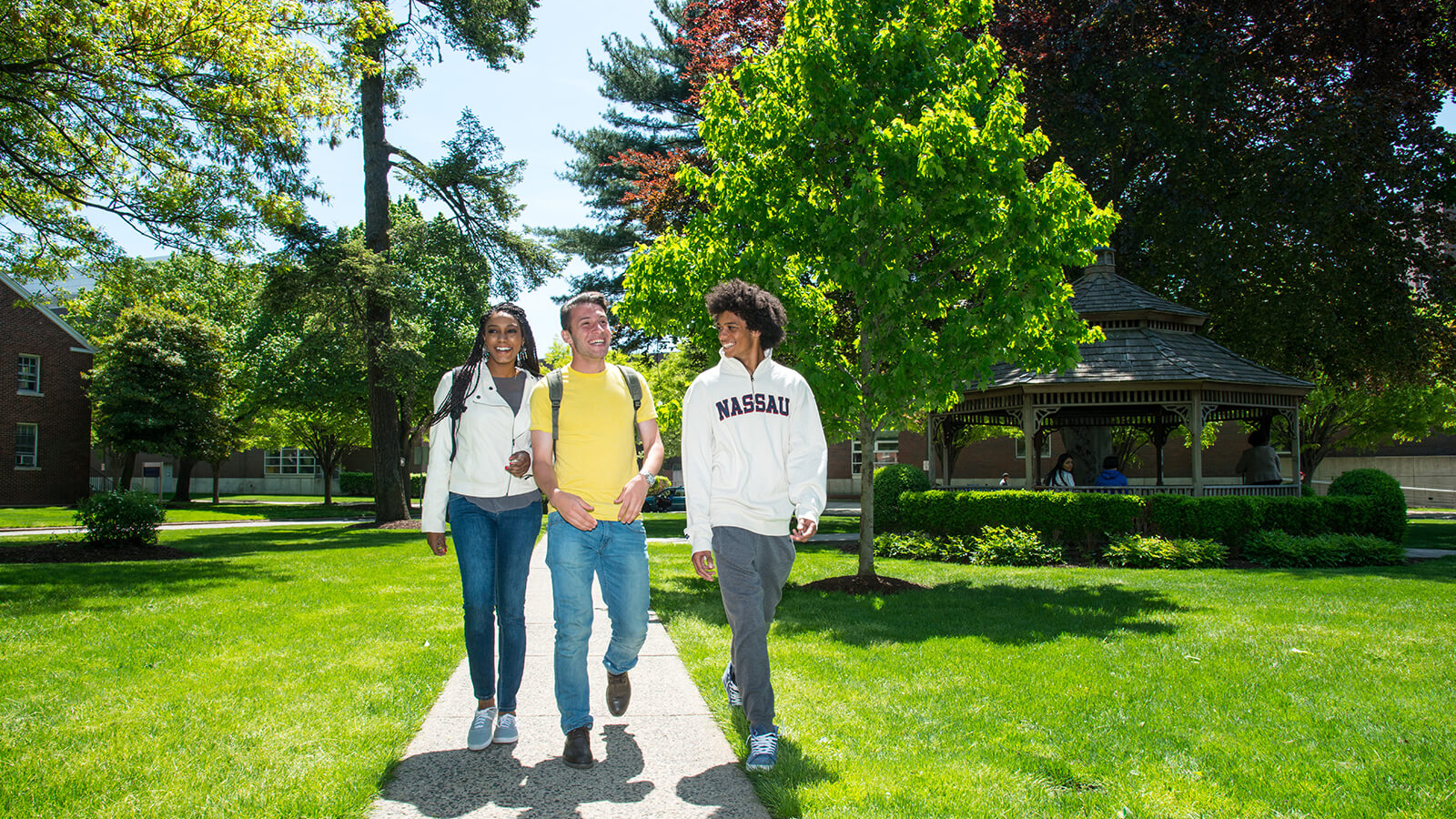 Three students walking together on campus