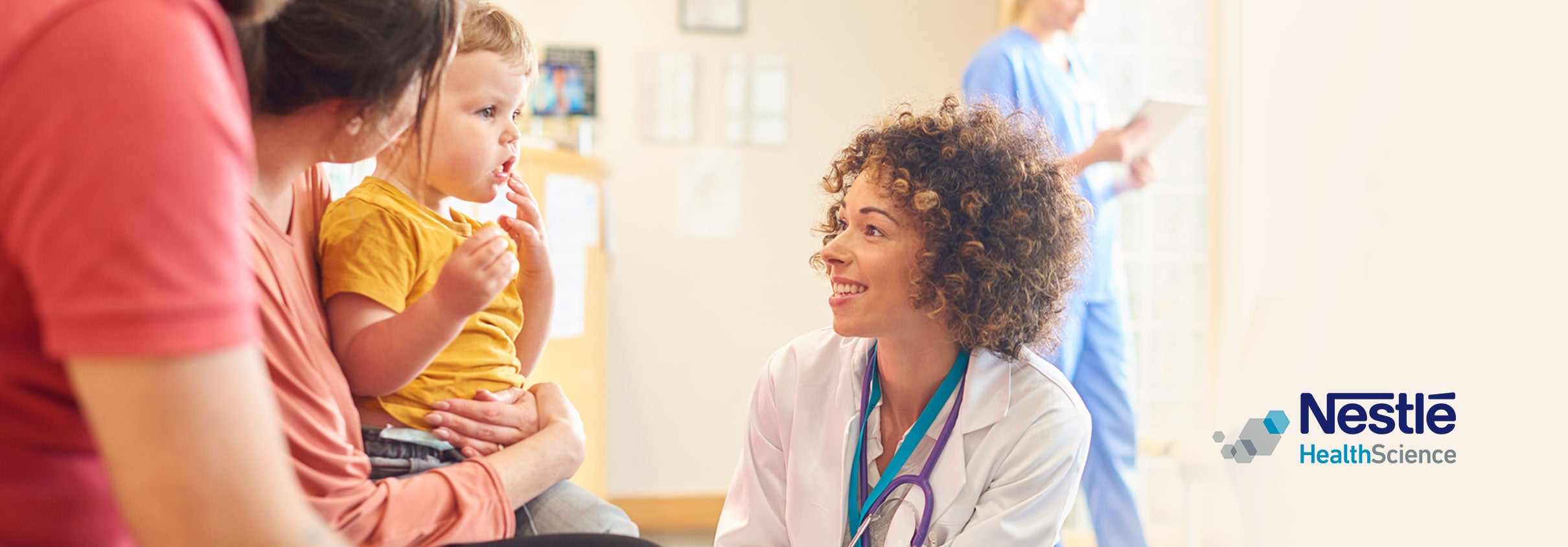 Female doctor talking to a little boy and his parents