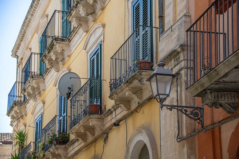 old colorful buildings seen while seeing Sicily by car