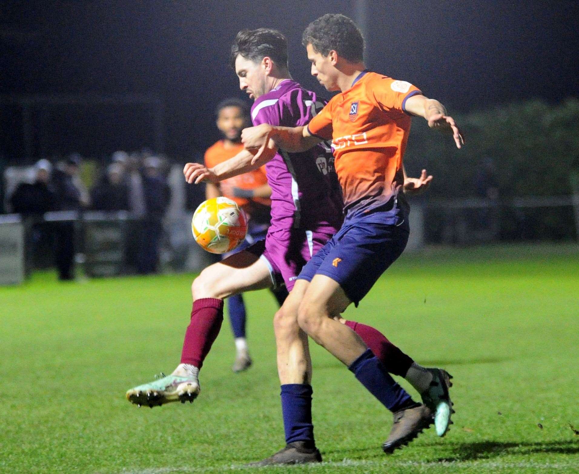 Newark & Sherwood (orange) close down Bourne Town at the Abbey Lawn on Tuesday night. Photo: Chris Lowndes