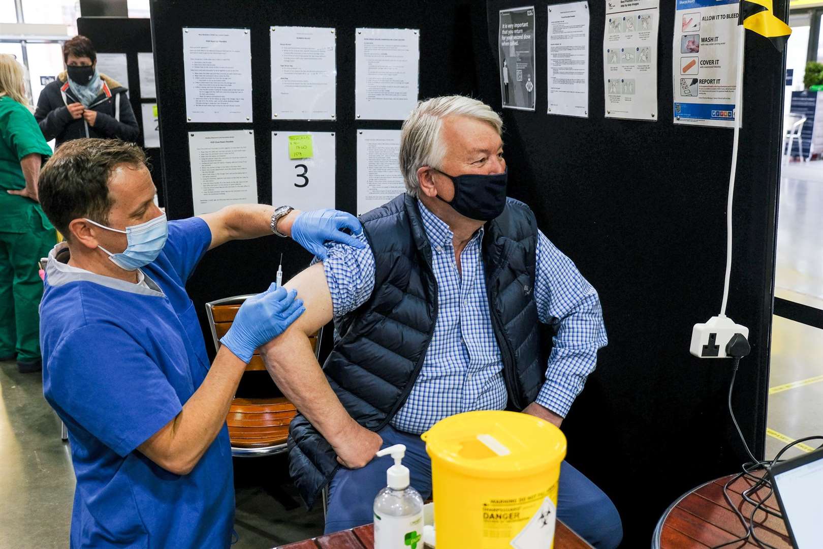 Dr Ben Curtis from the Downland practice gives the second vaccine to David Ball MBE. Picture Phil Cannings