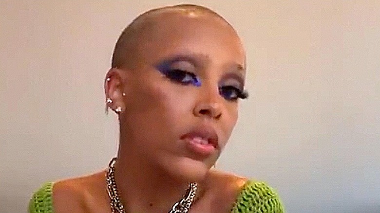 Doja Cat with shaved eyebrows and head