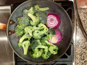 broccoli and onion in frying pan