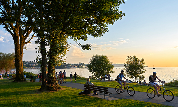 people walking and biking through green space of community