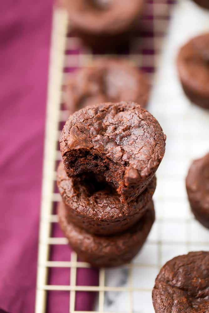 stack of 3 brownies shaped like muffins with purple towel in background