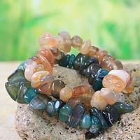 Beaded stretch bracelets, 'Green Orange Odo Tintine' (pair) - Beaded stretch bracelets (Pair)