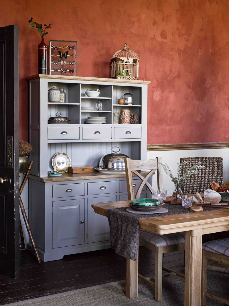 Grey dresser and oak table in kitchen