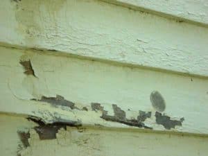 Layers of paint on wood siding on an historic house