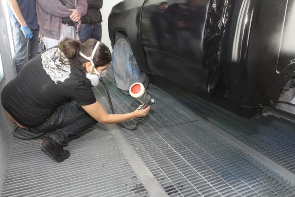 spraying rocker panel on a truck with paint