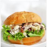 chicken salad with apples, cranberries, and pecans on a gluten-free bun