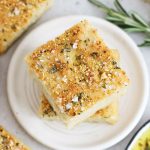 squares of gluten-free focaccia stacked on a white plate