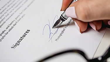 Hand signing a contract