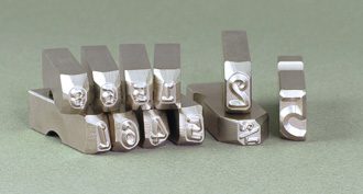 steel type stamps with engraved with numbers and letters, with retaining slots for use in type holders