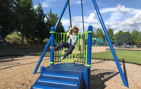 Boy on zip line at Fisher Creek Park in Snoqualmie best parks and playgrounds pandemic Seattle