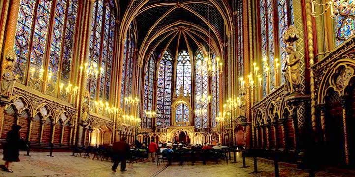 A classical music concert performed at the stunning and golden interior of La Sainte Chapelle in Paris with its soaring stained glass windows