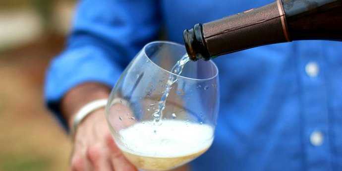 Champagne being poured in a glass during a day tour of the Champagne Region