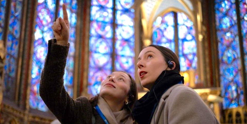 Tourists and a guide at La Sainte-Chapelle during a tour that includes Conciergerie, Notre Dame