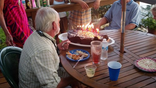 fish shaped birthday cake with some lit candles