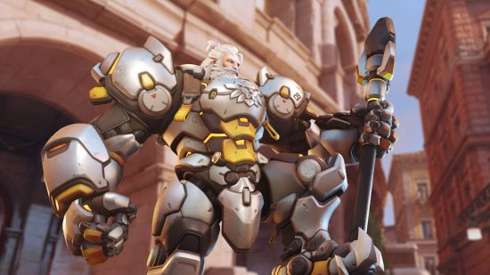 Overwatch 2 tier list: Reinhardt is wearing a full suit of armor but no helmet. He has a massive hammer.