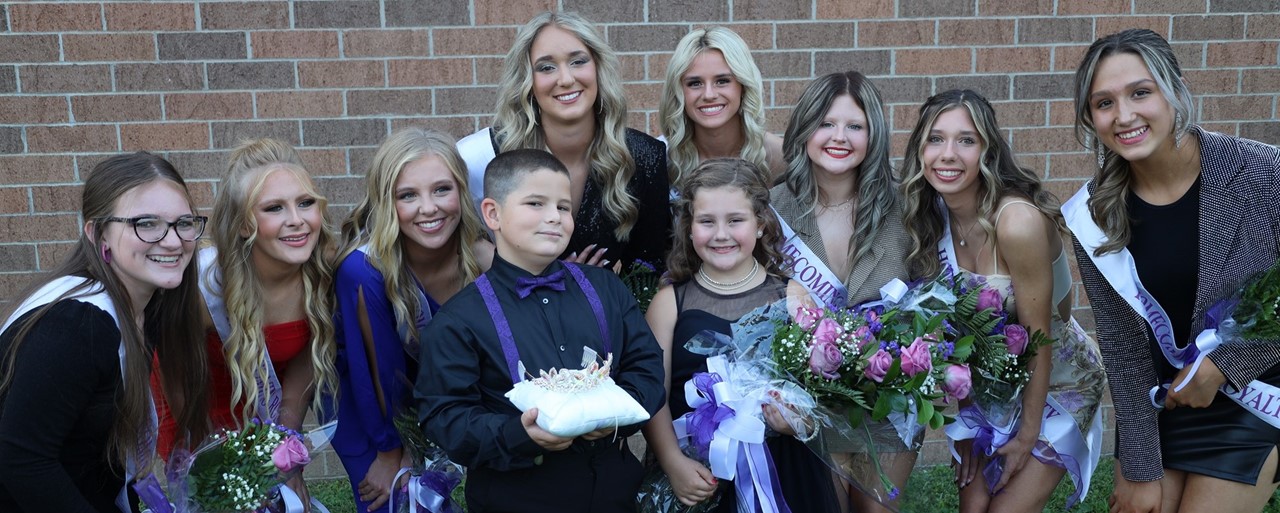 girls wearing formal wear smiling and holding flowers