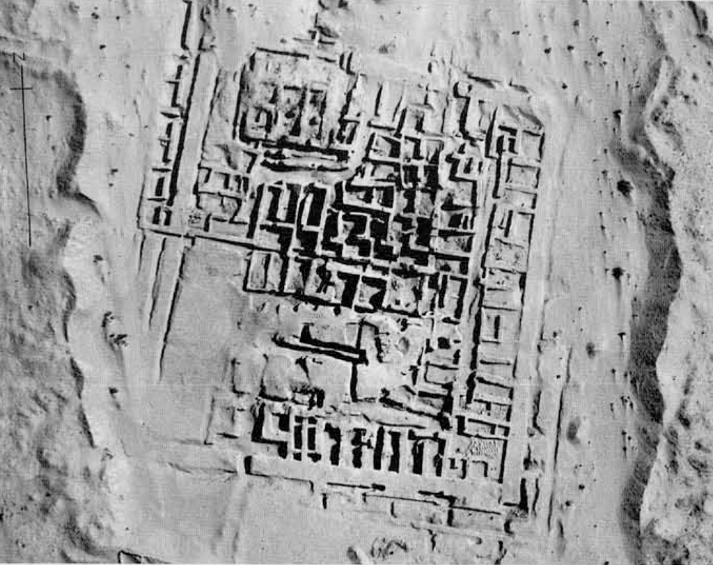 Aerial view of an excavated site showing rectangular walls forming buildings and streets.