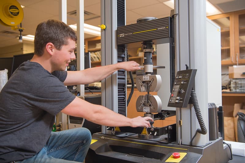 PennWest student working with a machine. 