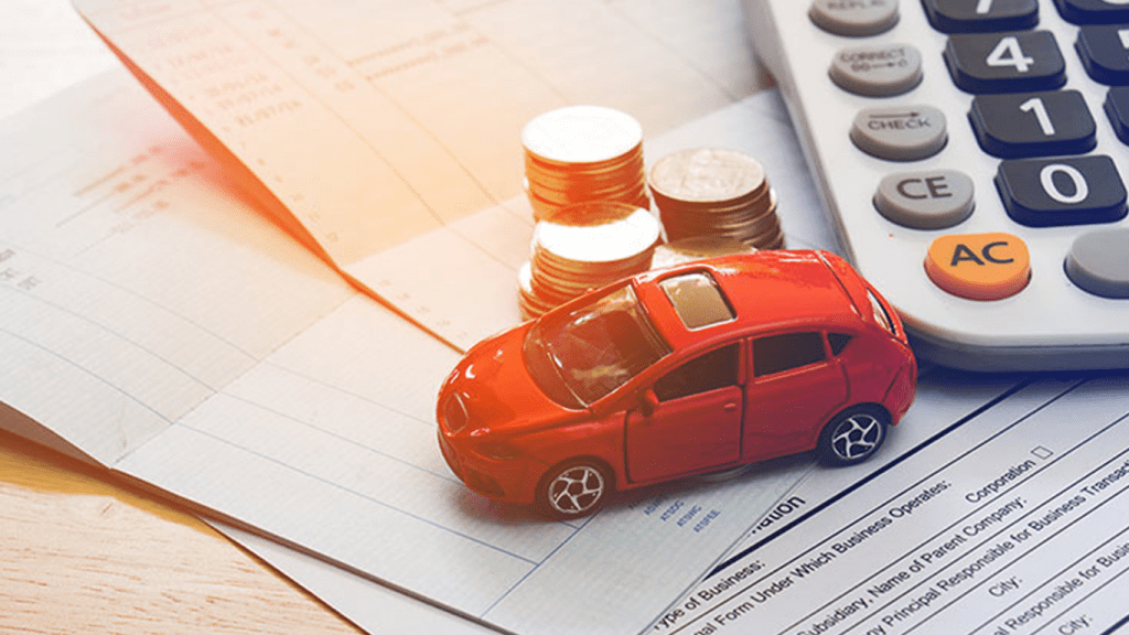 toy car, money, and calculator signifying car insurance