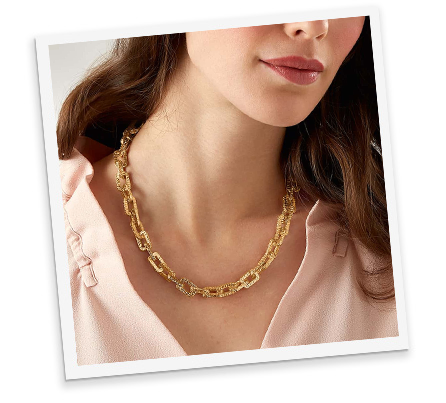 Head shot of a woman in front of a pale grey background shown from the nose to chest wearing a white top and layered double-strand beaded necklace made from faceted crystal in iridescent blue and honey yellow with freshwater pearls, agate and shell coloured pale blue.