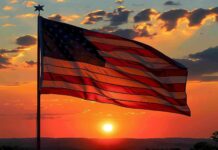 American flag with a sunrise backdrop.