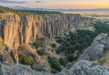 A panoramic view of the Rocky Mountains during sunrise.