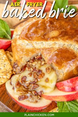 Baked brie on a platter with crackers and apples