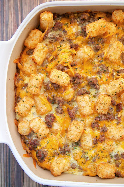 Tater Tot Sausage Breakfast Casserole - great make ahead recipe!  Sausage, cheddar cheese, tater tots, eggs, milk, garlic, onion and black pepper. Can refrigerate or freeze for later. Great for breakfast. lunch or dinner. Everyone loves this easy breakfast casserole!!